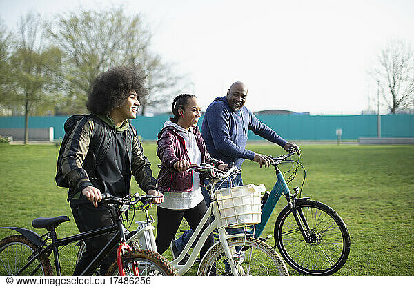 Family with bicycles in park grass