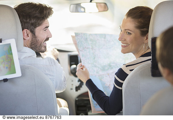 Family with map inside car