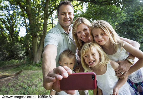 Family with three children  taking a selfie.