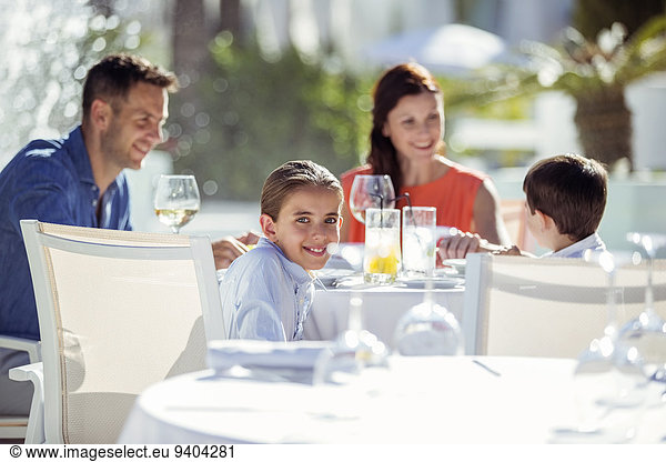 Family with two children having dinner in resort outdoors