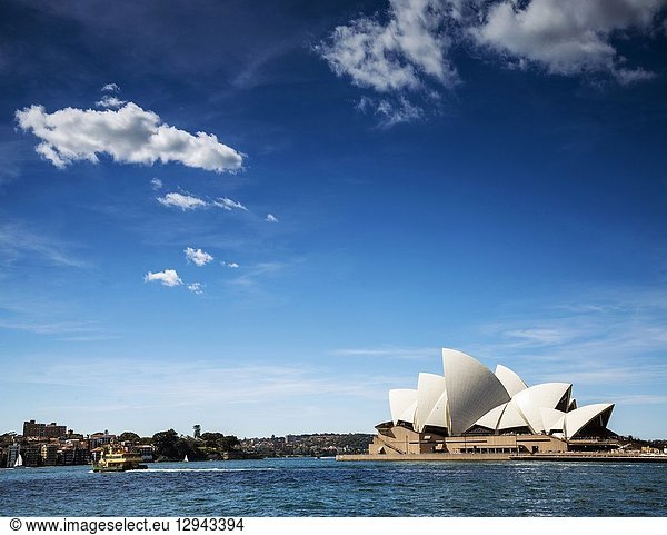 Famous sydney landmark opera house view with ferry boat in australia on sunny day.