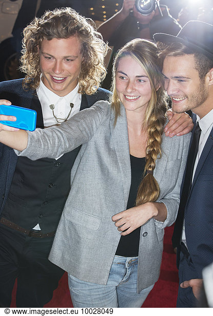 Fan taking selfie with celebrities at event