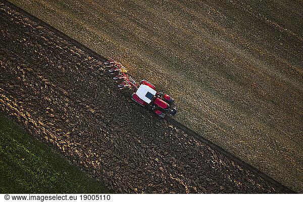 Farmer working with tractor in field