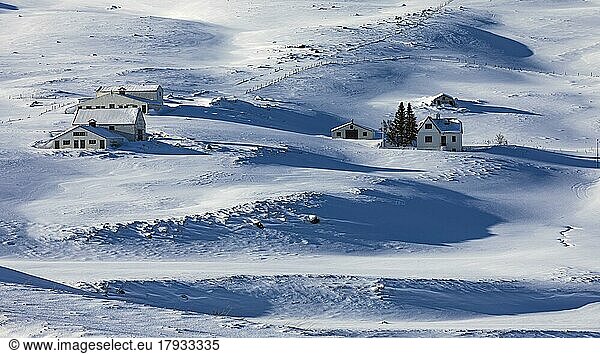 Farmhouse in snow-covered hilly landscape  near Akureyri  North Iceland Eyestra  Iceland  Europe