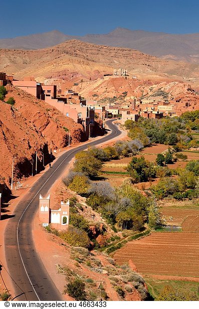 Farmland and red rock hills along road in Dades Gorge in the High Atlas mountains Morocco