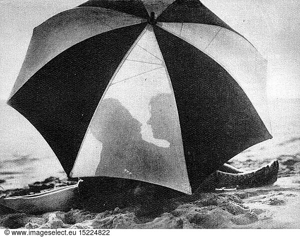 fashion  accessories  couple on the beach behind sunshade  1928