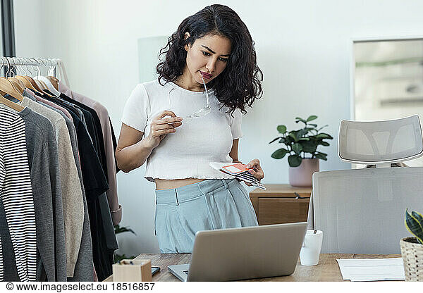 Fashion designer checking color swatch in studio
