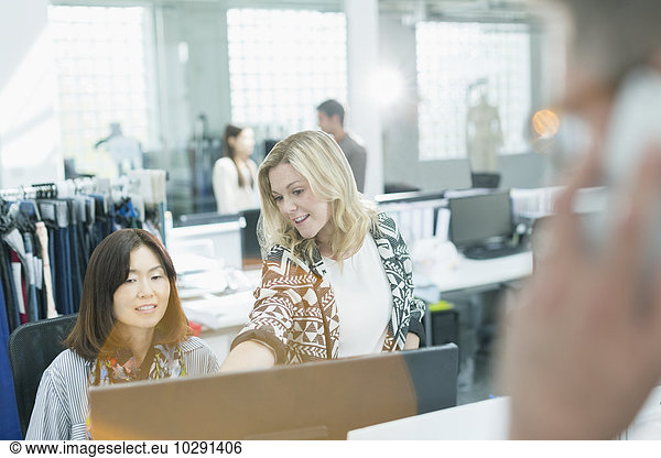 Fashion designers working at computer in office