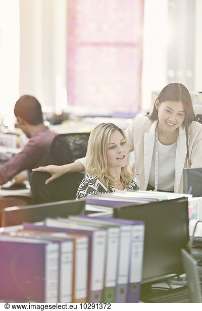 Fashion designers working at desk in office