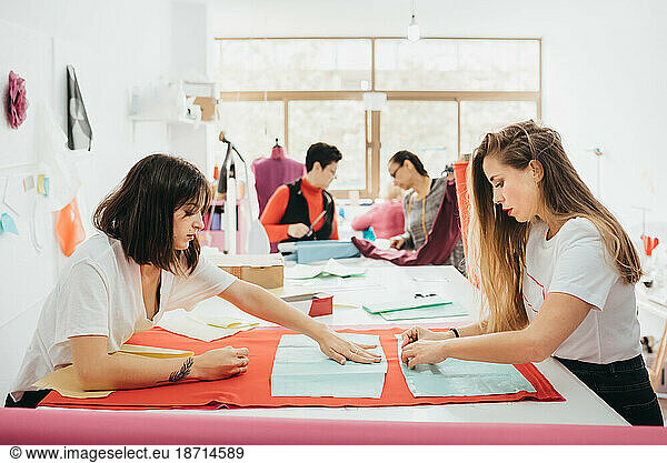 Fashion designers working in the design studio