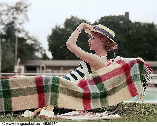 fashion  ladies' fashion  woman on sunlounger at swimming pool  1960s