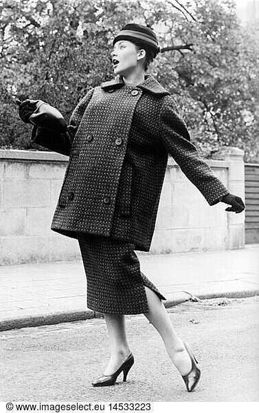 fashion  ladies' fashion  woman wearing ladies' suit  standing on a street  1957
