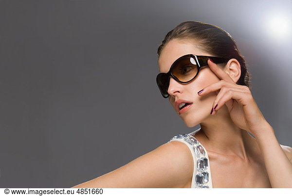 fashion model in glasses looking off camera