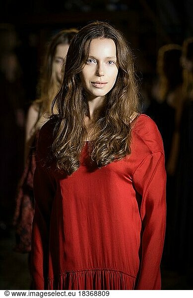 Fashion model in long wide designers dress at night show outdoor