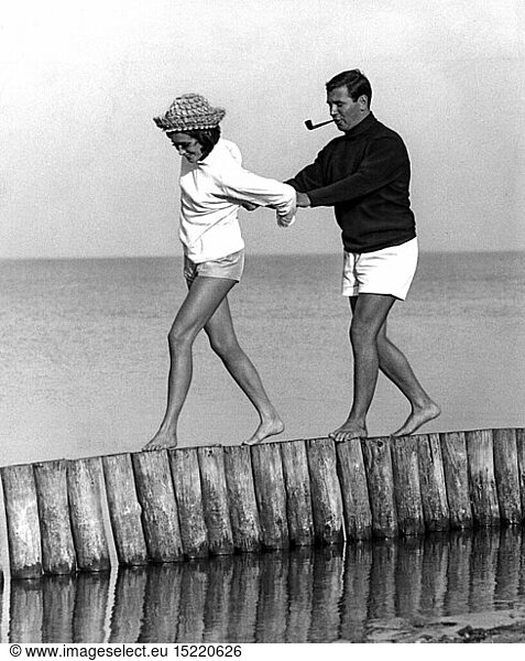 fashion  1960s  beach fashion  couple in bathing wear on the beach  1960s