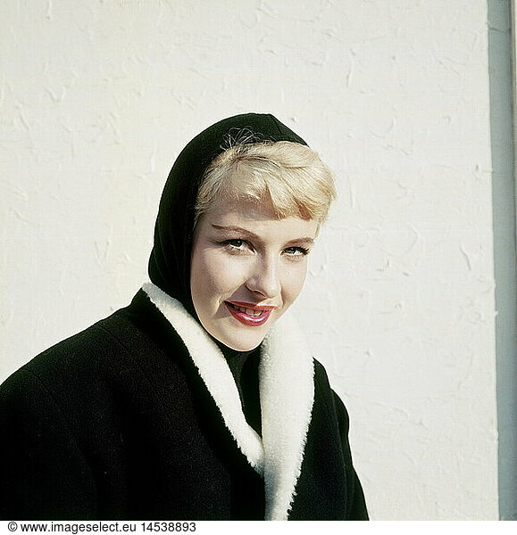 fashion  1950s  ladies' fashion  winter collection  woman wearing black headscarf and black coat with white fur collar