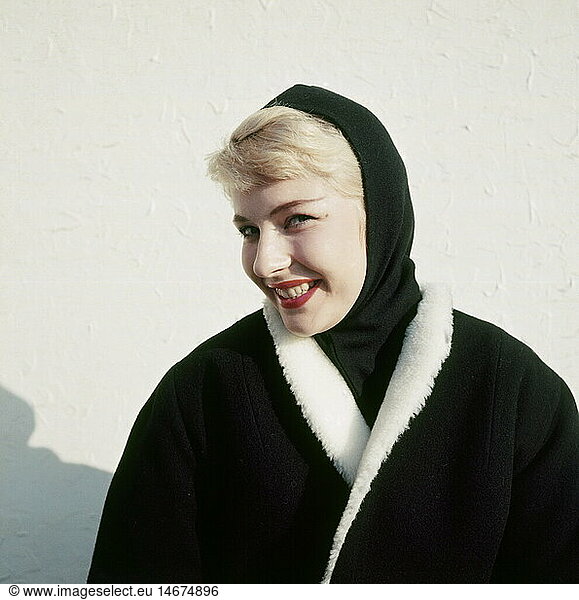 fashion  1950s  ladies' fashion  winter collection  woman wearing black headscarf and black coat with white fur collar