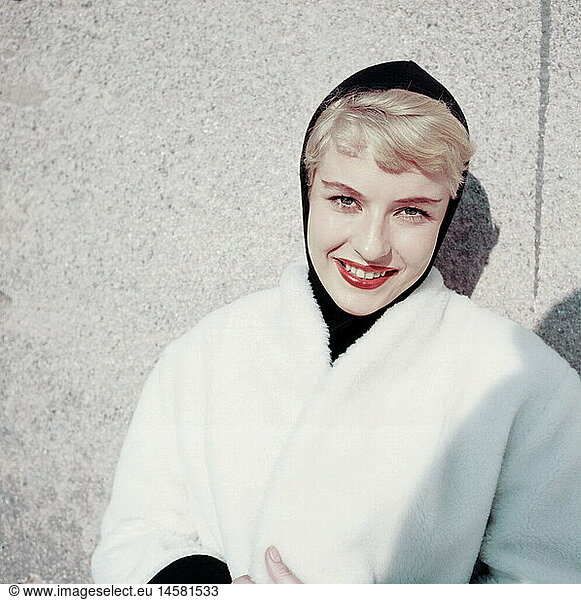 fashion  1950s  ladies' fashion  winter collection  woman wearing black headscarf and white coat with white fur collar