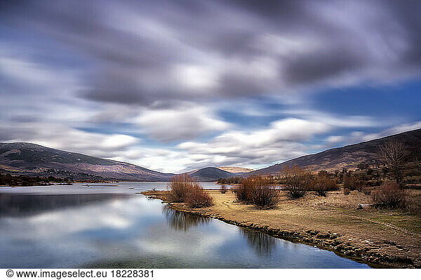 Fast clouds over Pinilla del Valle reservoir  in Madrid province.