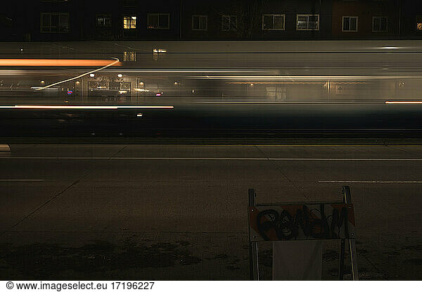 Fast Passenger Train Moves Through a Street at Night (Motion Blur) B