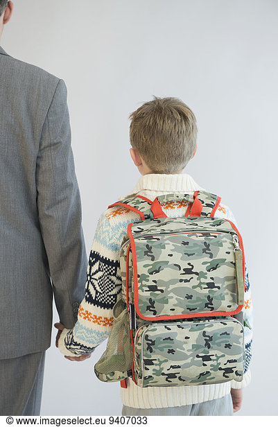 Father accompanying his son to school