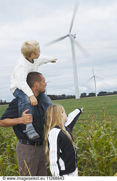 Father and Children Looking at Wind Turbines  Denmark