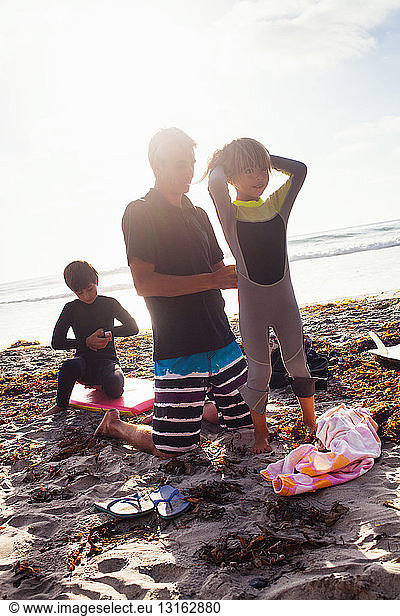 Father and children preparing to surf  Encinitas  California  USA