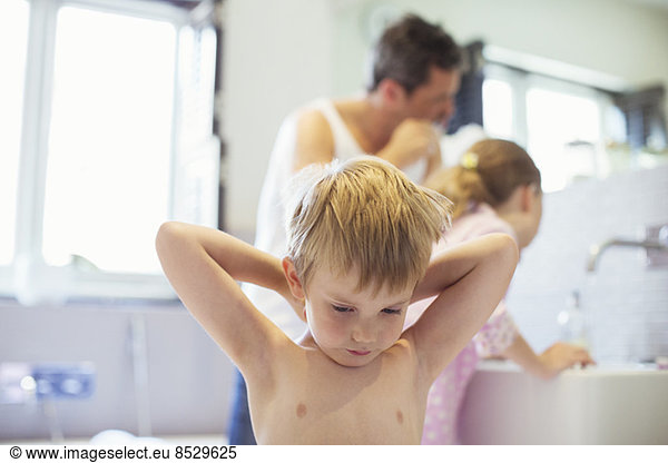 Father and children washing up in bathroom