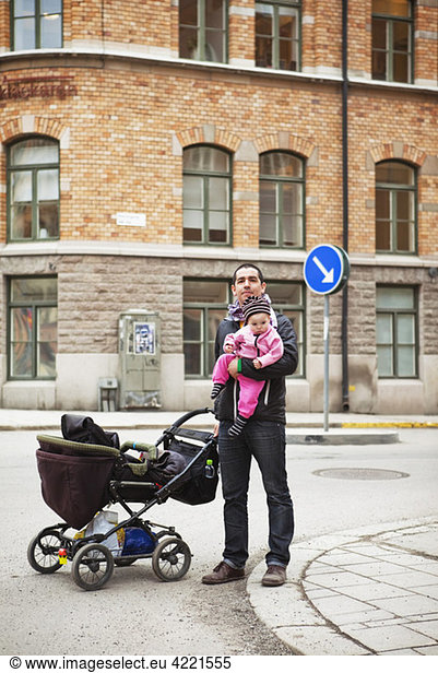Father and daughter downtown with stroller