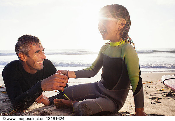 Father and daughter holding hands on beach  Encinitas  California  USA