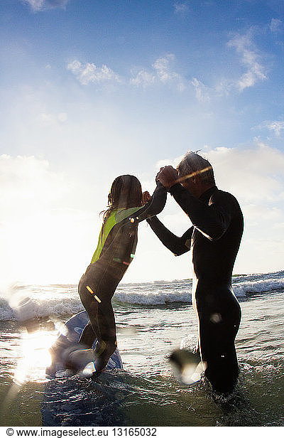 Father and daughter playing in sea  Encinitas  California  USA