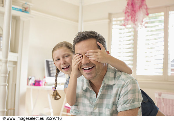 Father and daughter playing peek-a-boo