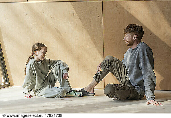 Father and daughter spending time together in wooden house