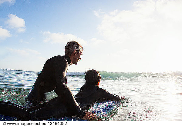 Father and son at sea with surfboard  Encinitas  California  USA