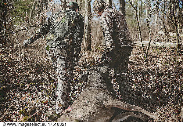 Father and son dragging dead 8 point buck out of Wisconsin woods