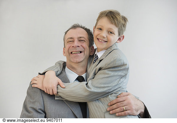 Father and son embracing each other  smiling  close up