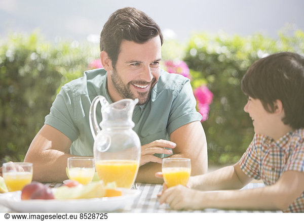 Father and son enjoying breakfast outdoors
