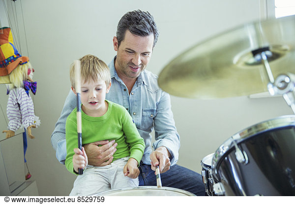 Father and son playing drums together