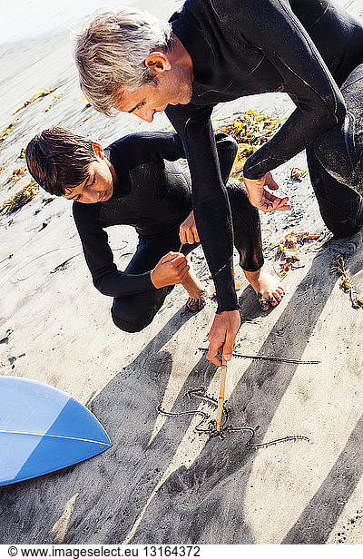 Father and son surfers at beach  Encinitas  California  USA