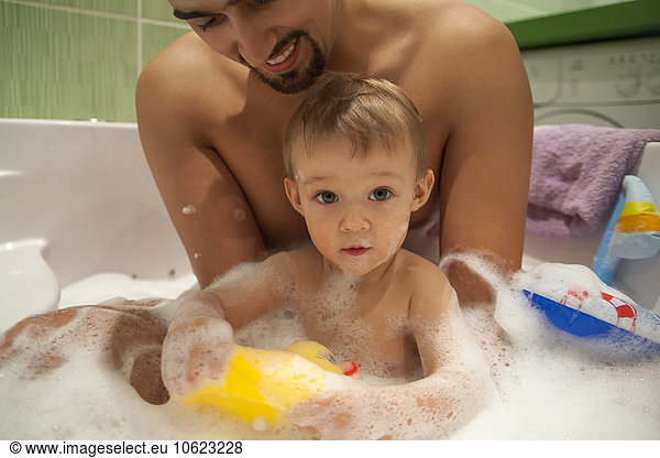 Father and son taking a bath together
