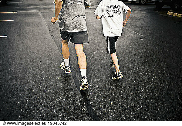 Father and son warms up in the parking lot for a 10k road race. Herndon  VA.