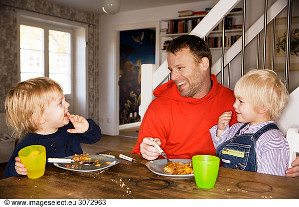 Father and sons eating together Sweden