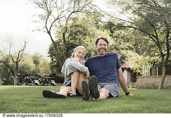 Father and Teenage Girl Smiling on a Grassy Lawn in Arizona