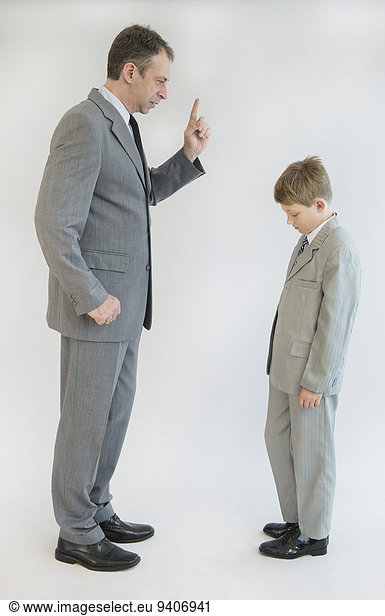 Father blusters his son against white background