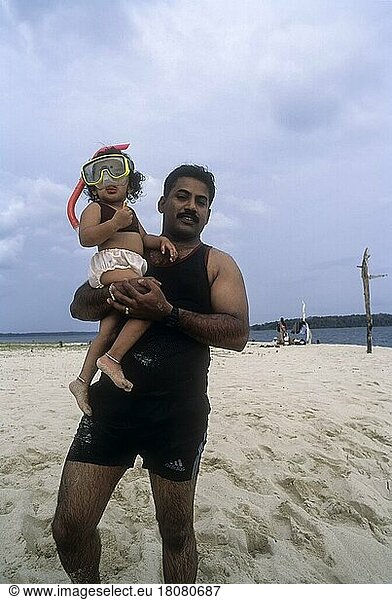 Father carrying his daughter in Jolly Buoy  Coral island  Andaman  India  Asia