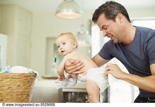 Father checking baby's diaper