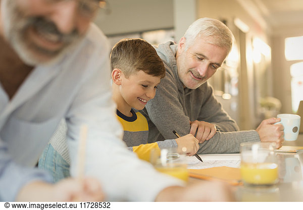 Father helping son with homework at counter