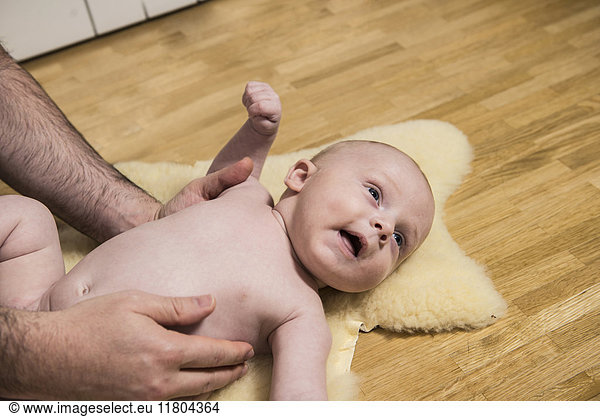 Father playing with his son while laying on floor