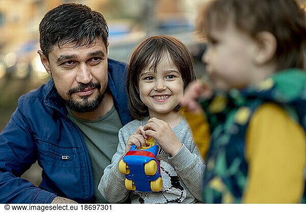 Father spending leisure time with sons at park