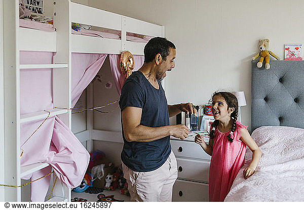 Father with daughter in bedroom